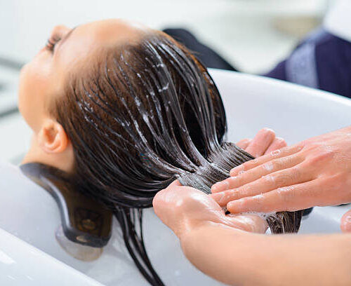 Professional treatment. Client is resting while her hair is being taken professional care.